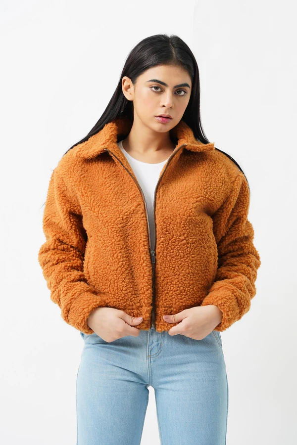 Woman wearing a luxurious faux fur jacket without a hood, showcasing its elegant design and plush texture.