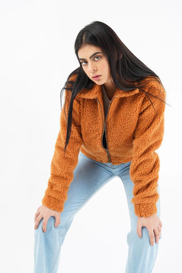 Woman wearing a luxurious faux fur jacket without a hood, showcasing its elegant design and plush texture.