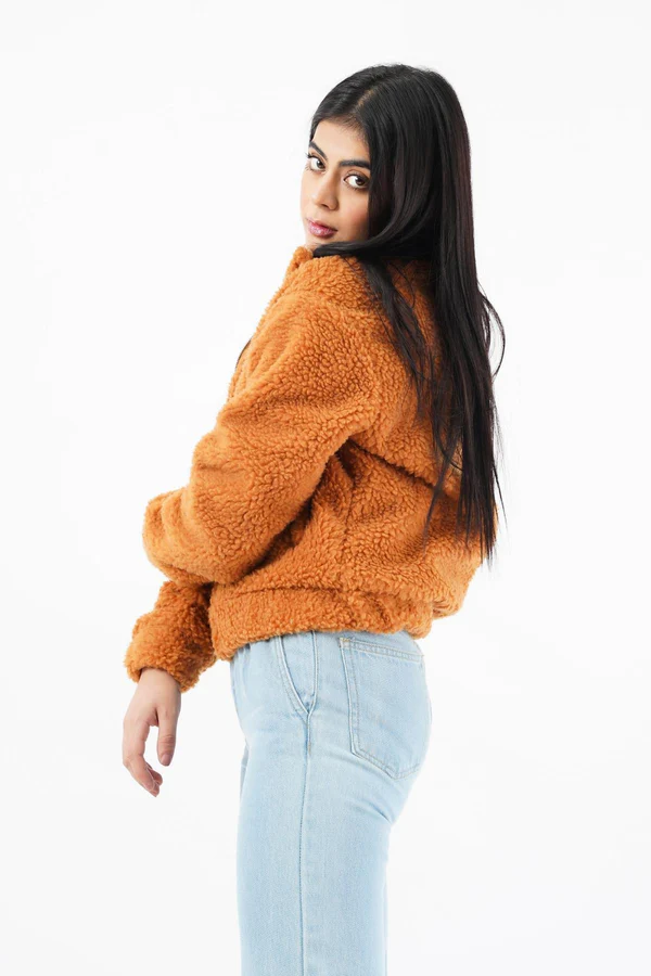 Woman wearing a luxurious faux fur jacket without a hood, showcasing its elegant design and plush texture.