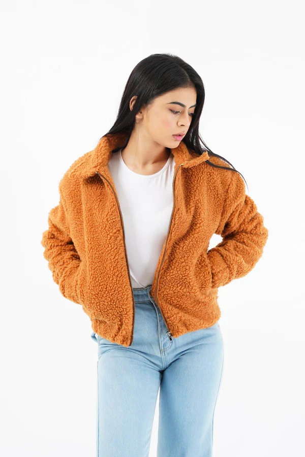Woman wearing a luxurious faux fur jacket without a hood, showcasing its elegant design and plush texture.