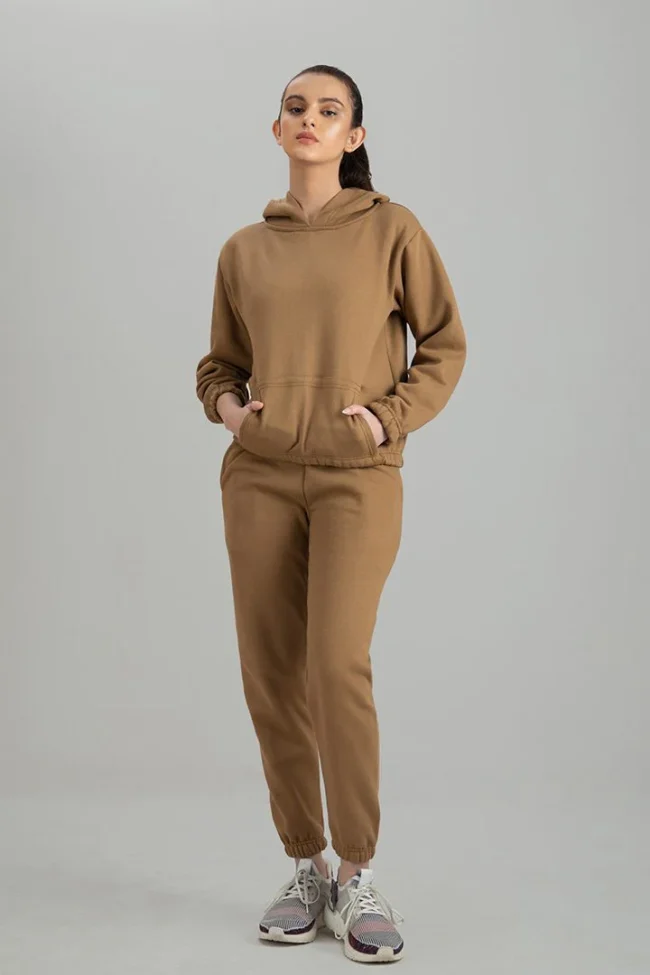 Woman wearing a stylish and comfortable premium tracksuit set, perfect for workouts and casual wear.