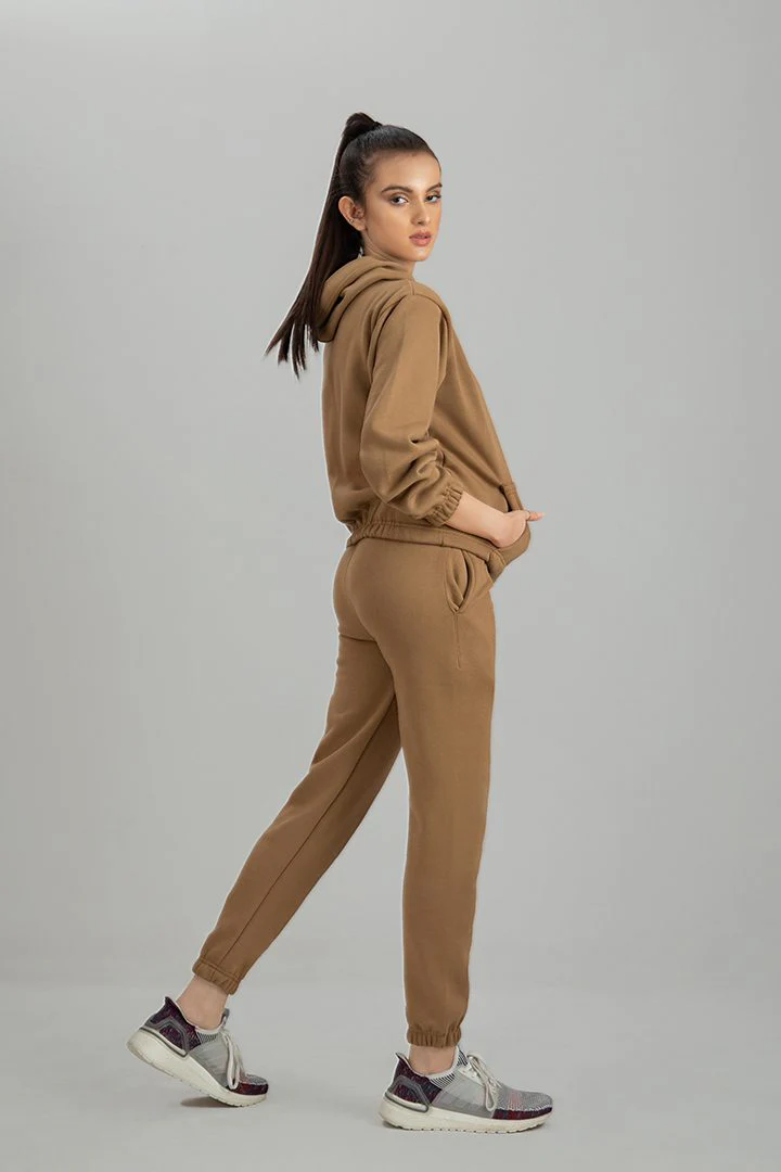 Woman wearing a stylish and comfortable premium tracksuit set, perfect for workouts and casual wear.