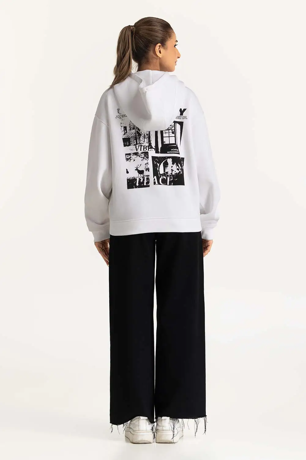 Model wearing a Women's Oversized Hoodie in heather gray, showcasing the relaxed fit and kangaroo pocket.